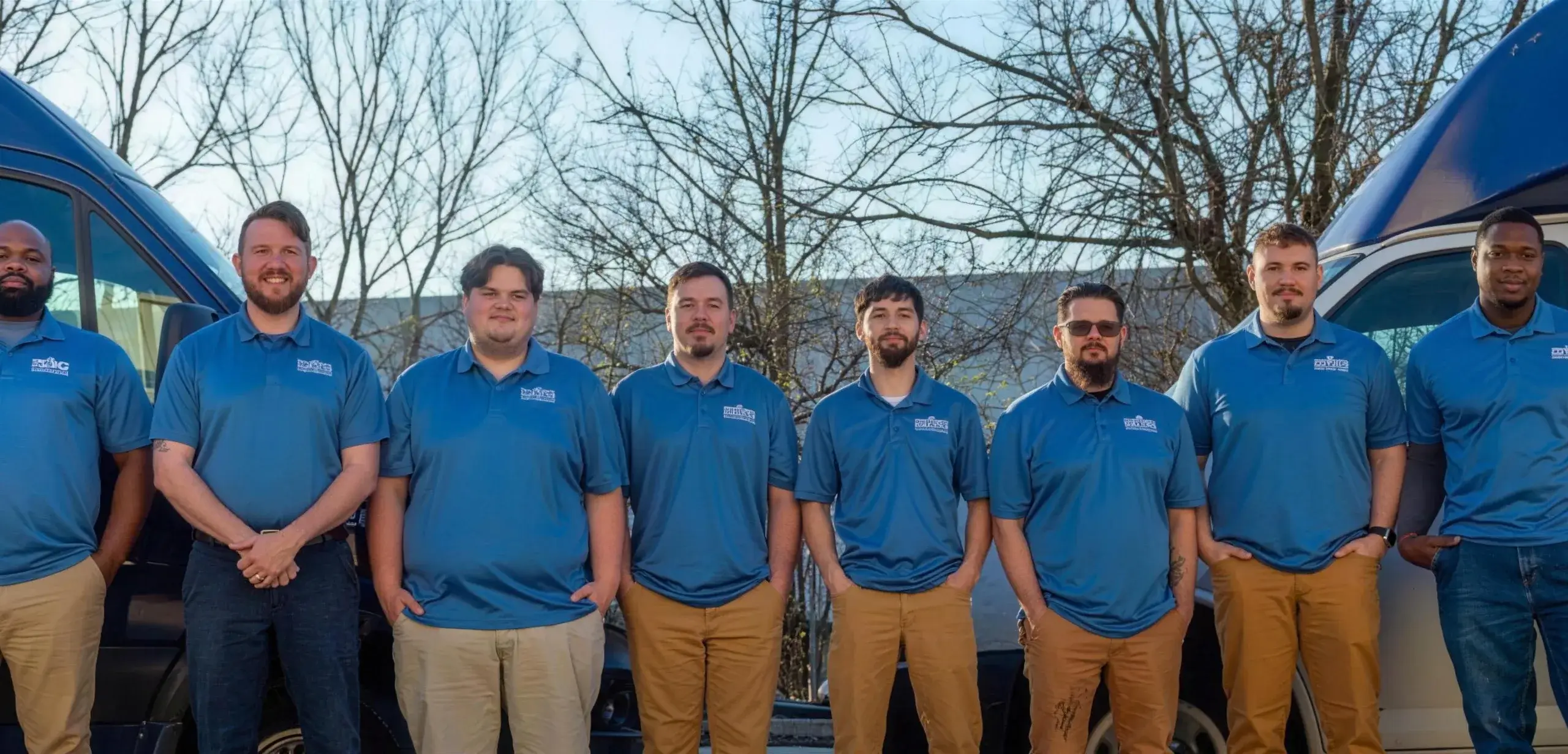 The Halpin Plumbing team standing in front of their service vans