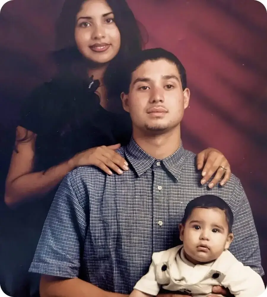 A young family portrait: Manny Sr. at 16 with his partner Juany and baby Manny Jr.