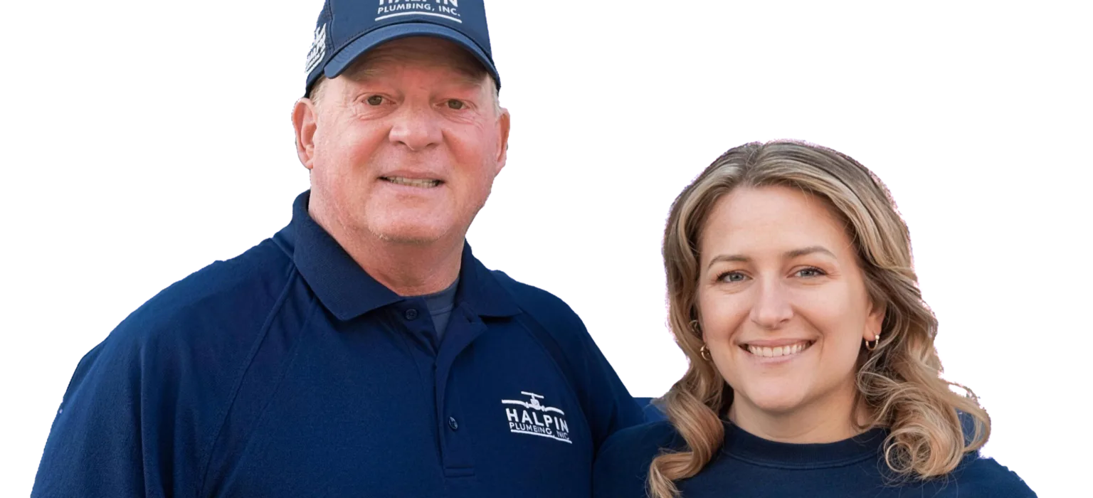 Two members of the Halpin Plumbing family in company shirts